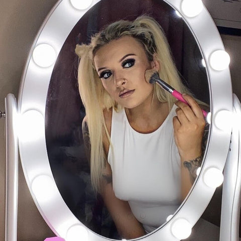 A woman doing her makeup in front of LUXFURNI Adjustable Hollywood Makeup Mirror