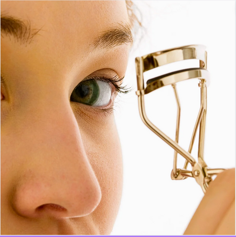 Woman lining her eyes with a makeup pencil