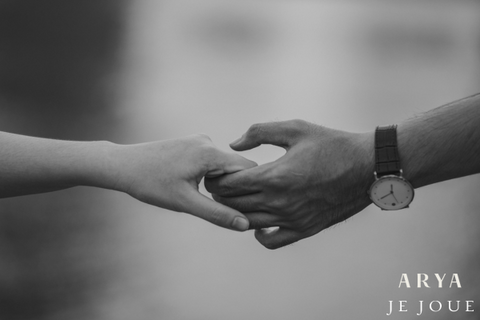 Black and white image of a man and a woman holding hands