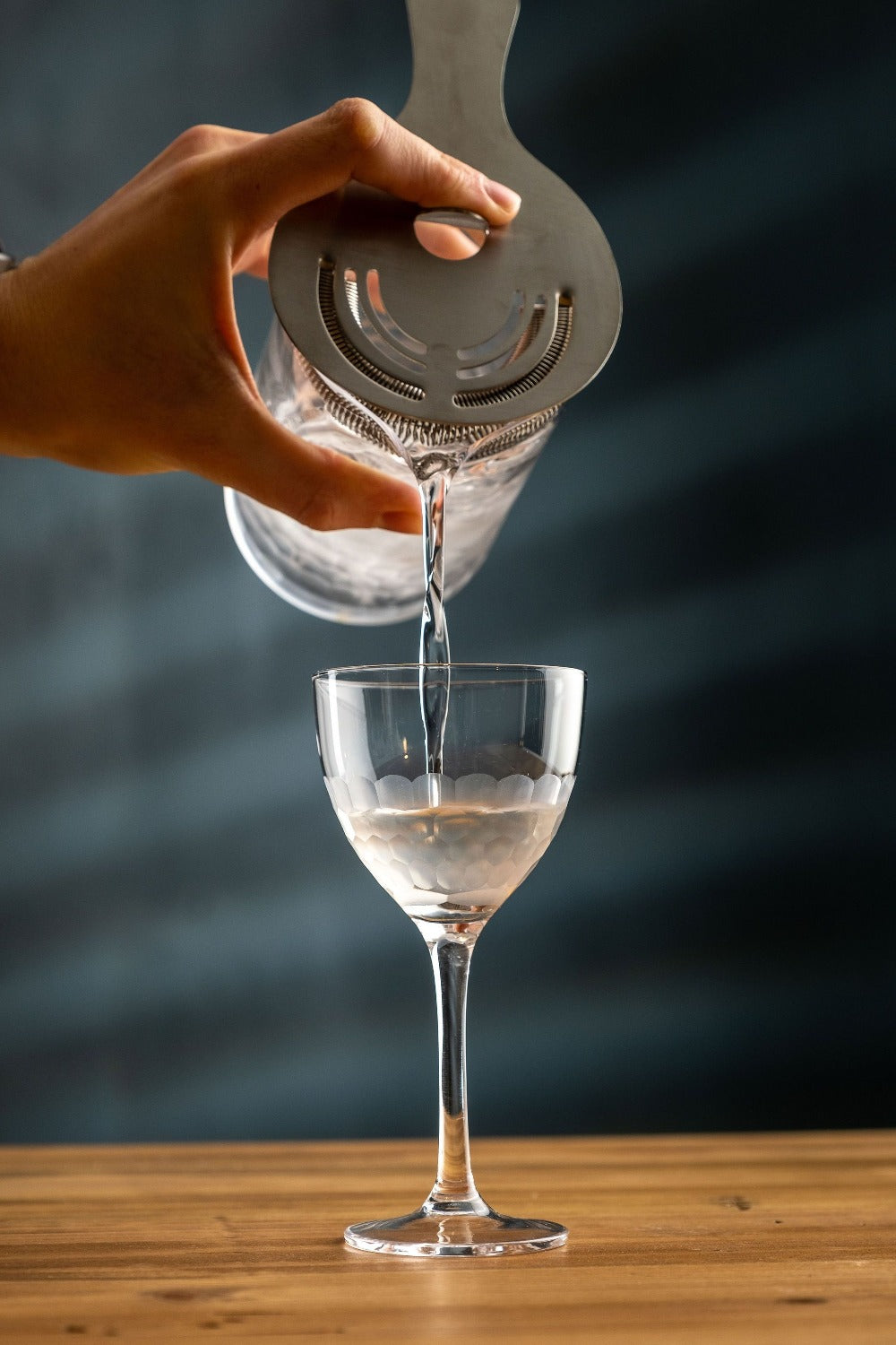 Martini being poured into a honeycomb nick and nora cocktail glass from amehla co. Photo by Jordan Hughes of High Proof Preacher.