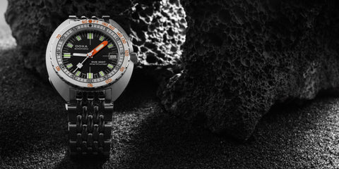 Doxa Sub 200T watch featuring a sleek design with a Black dial, luminous markers, and a rotating bezel.