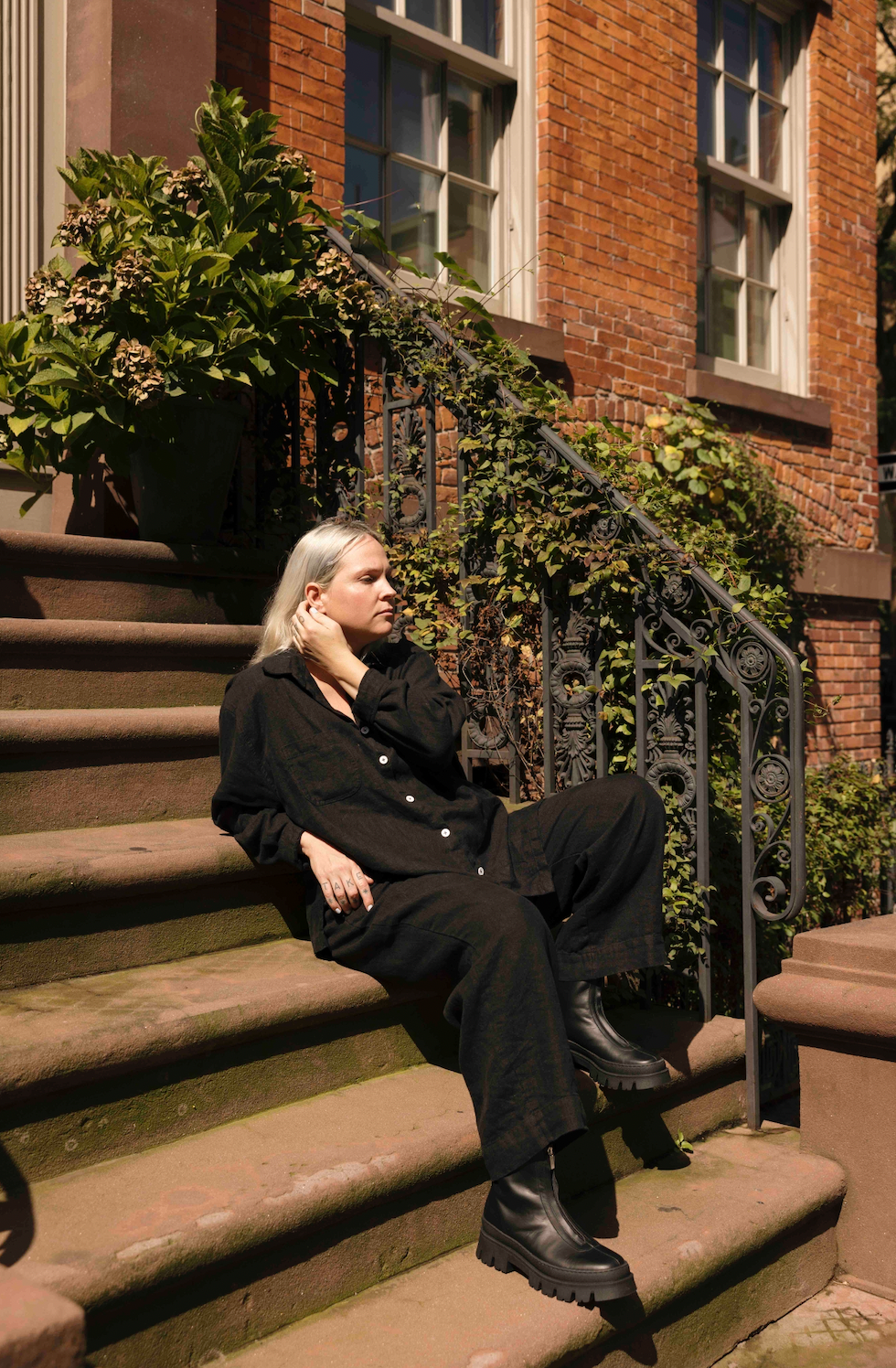 Shelter Clothing owner Alison, sitting on some steps in Brooklyn, New York