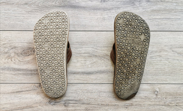 Before and after. A pair of sandals where one has had a resole and the other has not yet. Sandals by The Sole Workshop