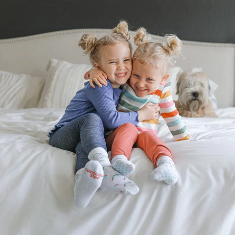 Two children wearing socks that save LGBTQ lives by Conscious Step