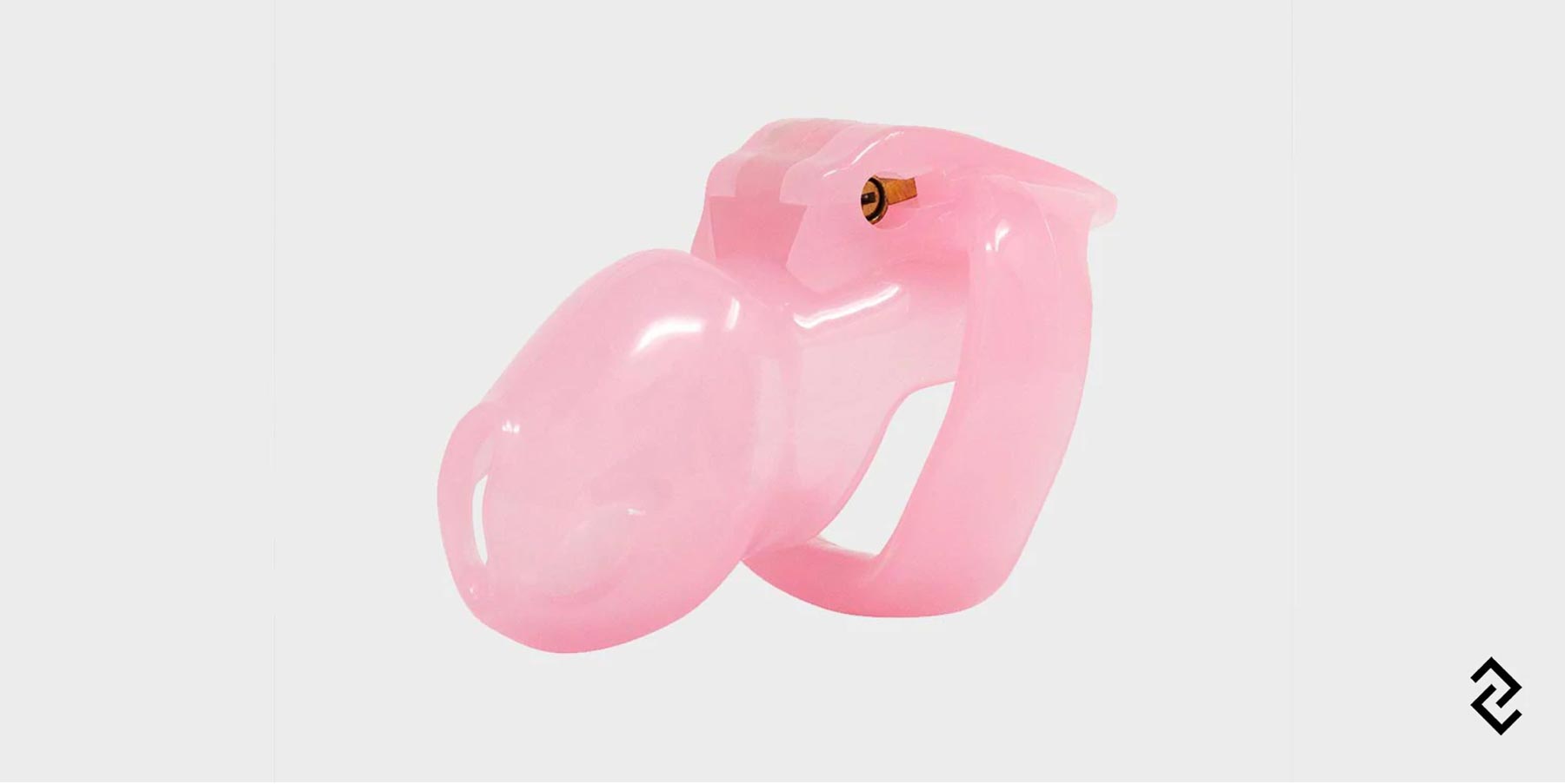 A 2 inch pink chastity cage designed to lock onto a man securely.