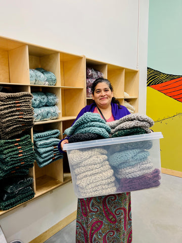 Local artisan team member with finished beanies