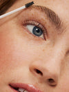 A woman using In Frame ILIA eyebrow gel.