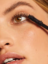 Woman applying ILIA conditioning mascara 