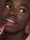 Woman applying ILIA Color Haze to lips
