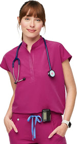 Nurse scrub top by FIGS style Rafaela in Raspberry Sorbet. It has a mandarin collar, shirt tail hem, 3 pockets and is made from 4-way stretch fabric.