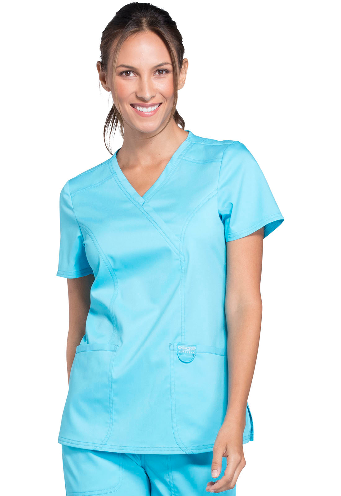 Nurse scrub top in colour Olive by Cherokee WW Revolution. It's a mock wrap with front yokes and back princess seams and side vents.