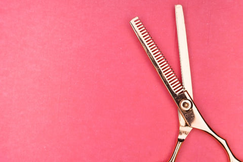 A pair of gold hair scissors