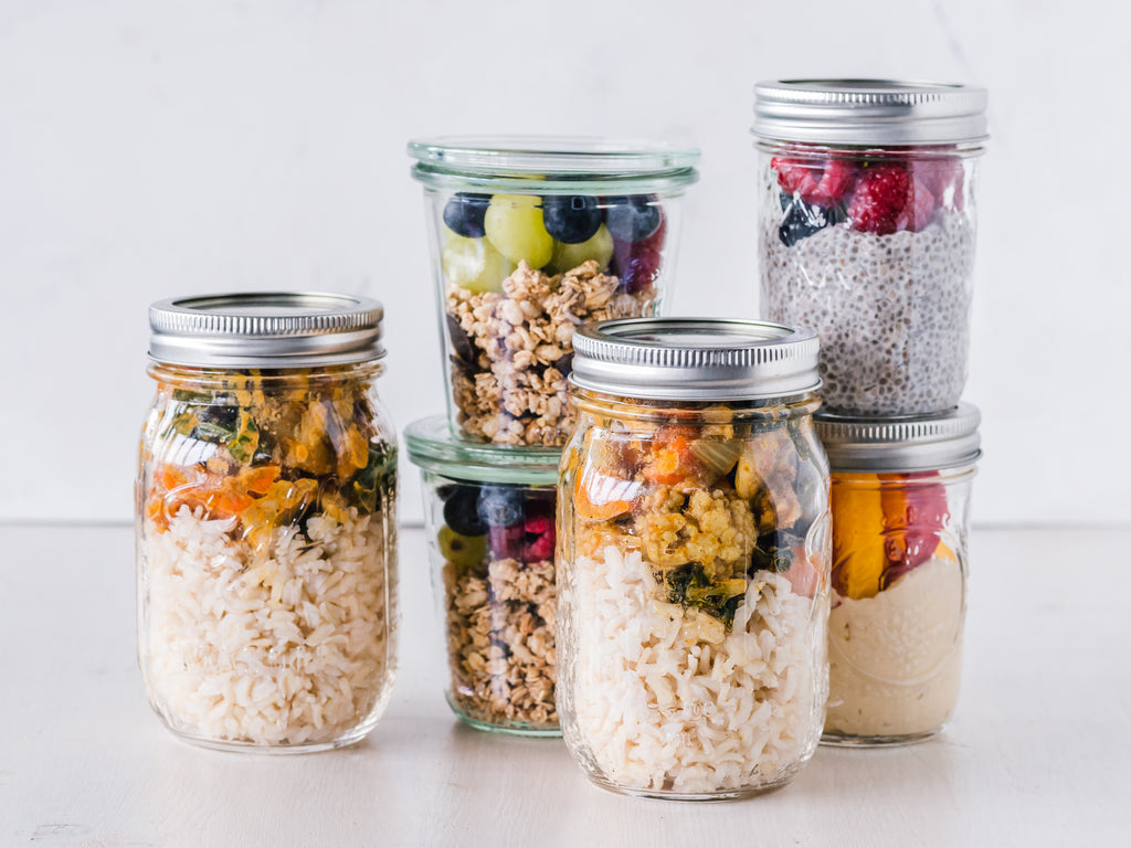 Meal planning example with clear glass jars with rolled oats and ready made snacks.