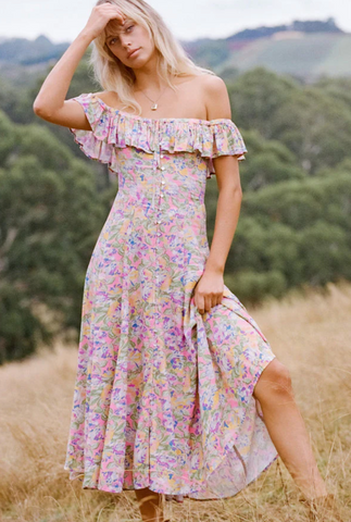 Dolly off-the shoulder dress on model standing in a wheat-grass field