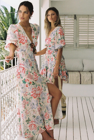 2 girls standing on a porch; one in long watson dress and one in the mini