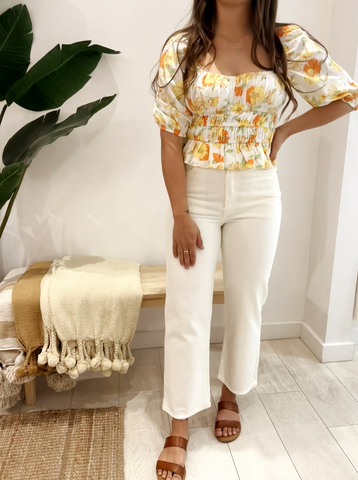 white levi jeans on girl with white & orange blouse