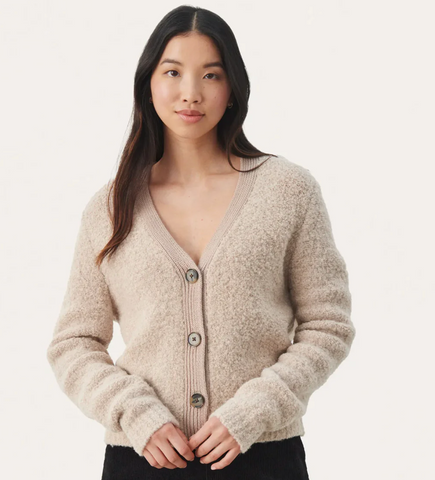 Cantella from part two - textured knit cardigan with long sleeves and a button up front. This blend is the coziest for the autmn air and perfect for layering through the winter.