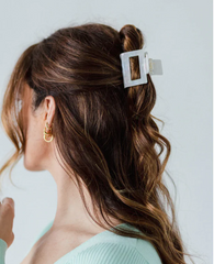 A Demi Clip hair clip from Supercrush holding up the hair of a model