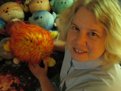 Noreen Grice holds the Sun plush toy in front of some of the other planets