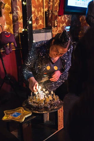 Sally starrider lighting candles on space cupcakes