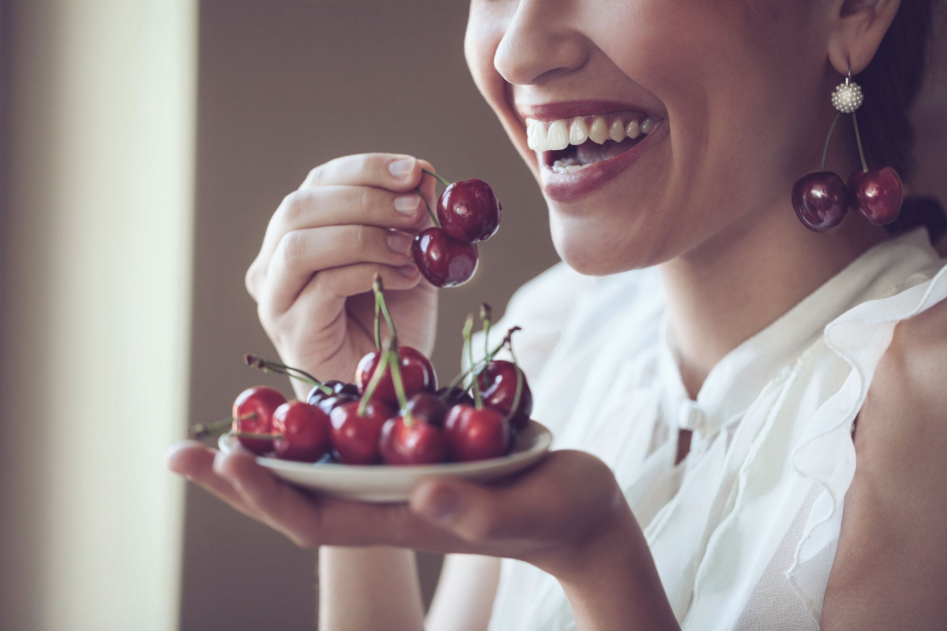 Girl enjoying cherry