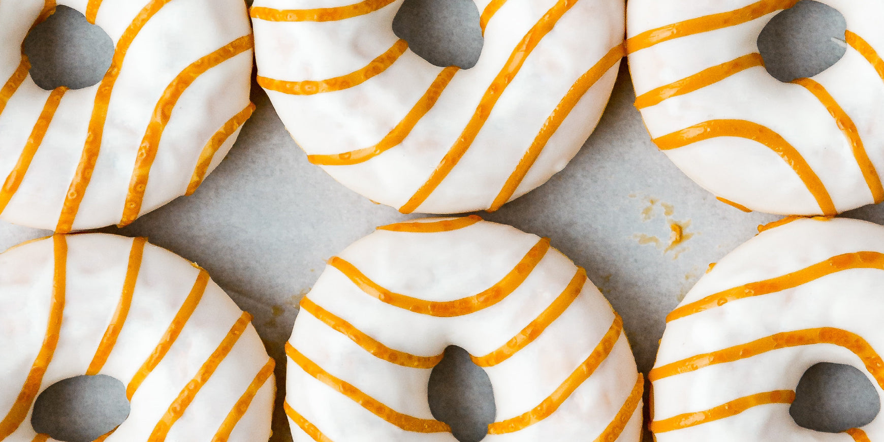White glazed doughnuts with orange icing