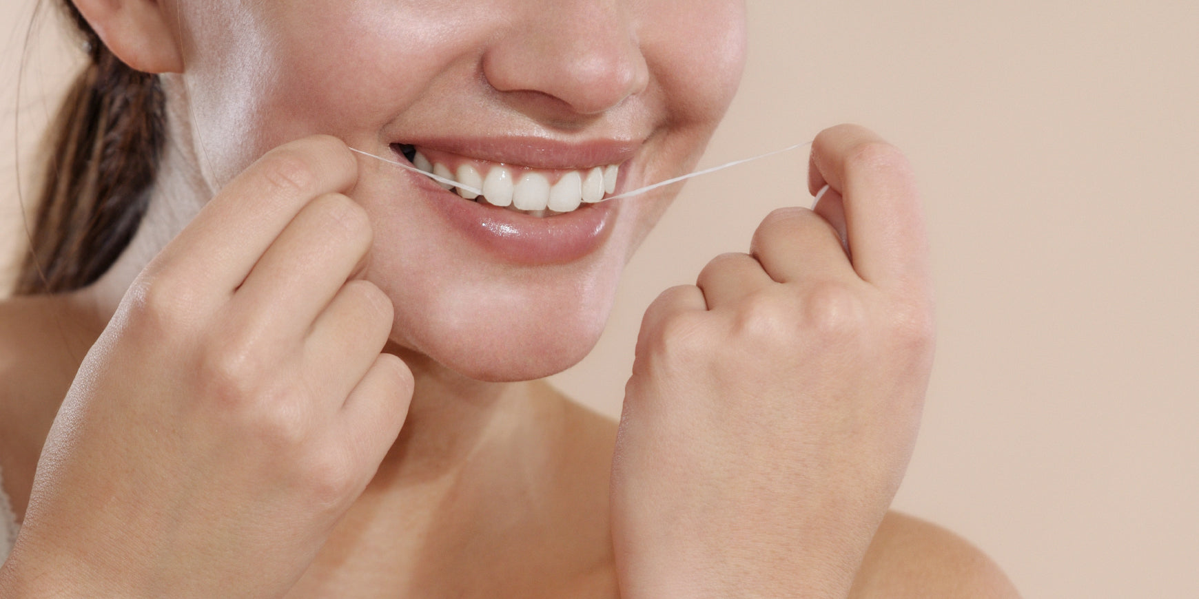 Woman smiling flossing teeth