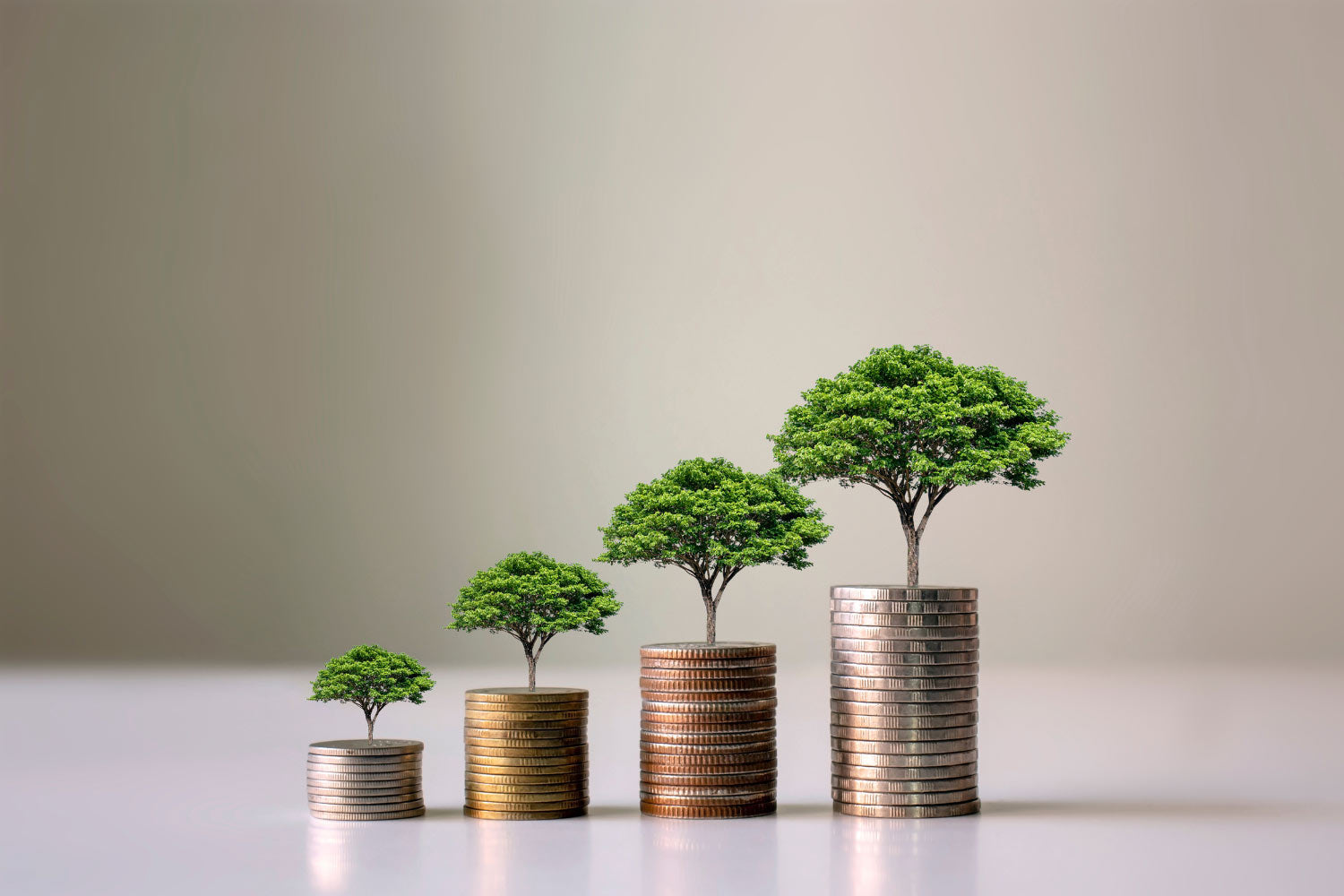 Four pile of coins with trees on top to illustrate that more money from industry bigger its impacts are