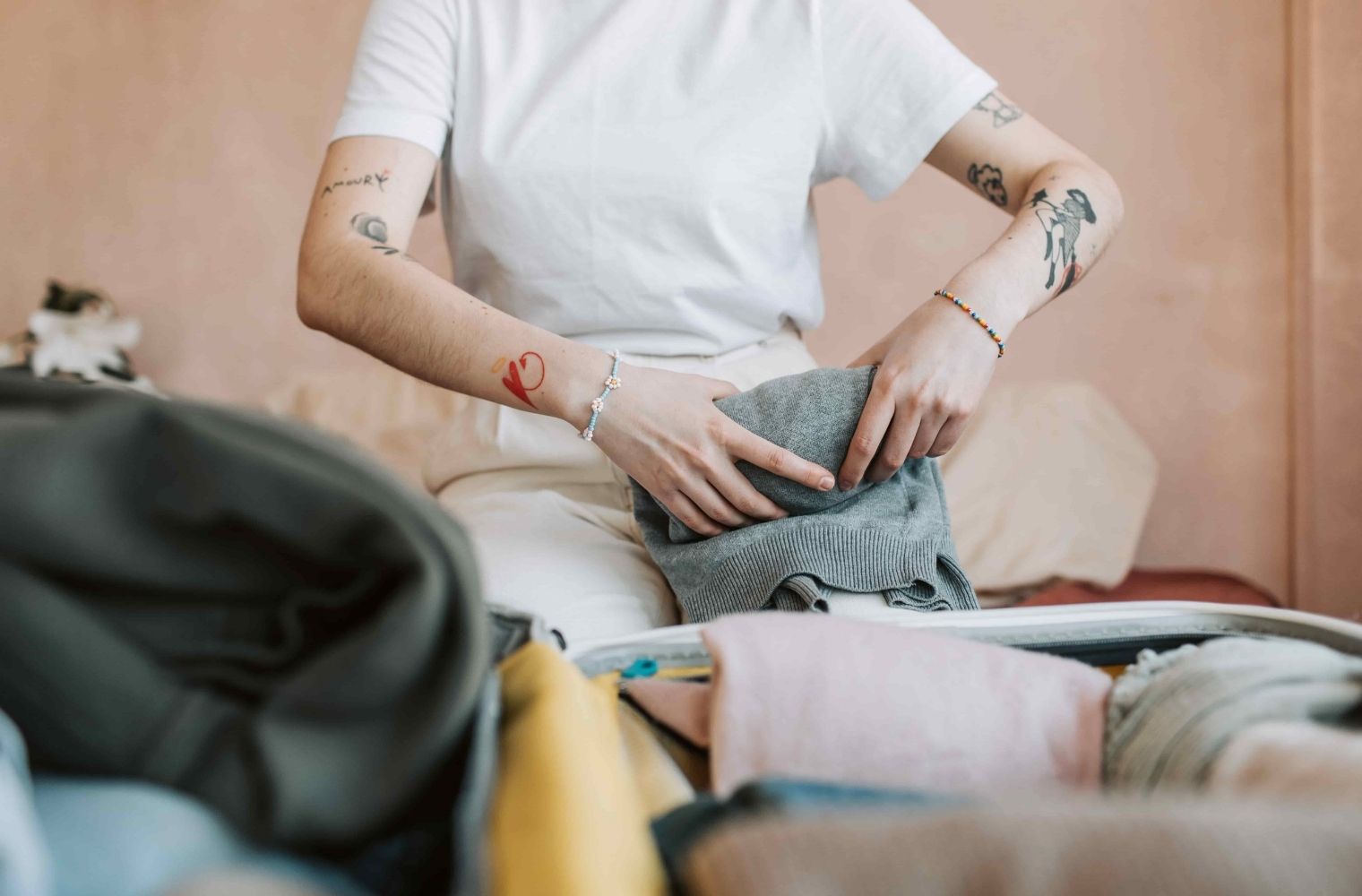 Close up of person packing clothes away