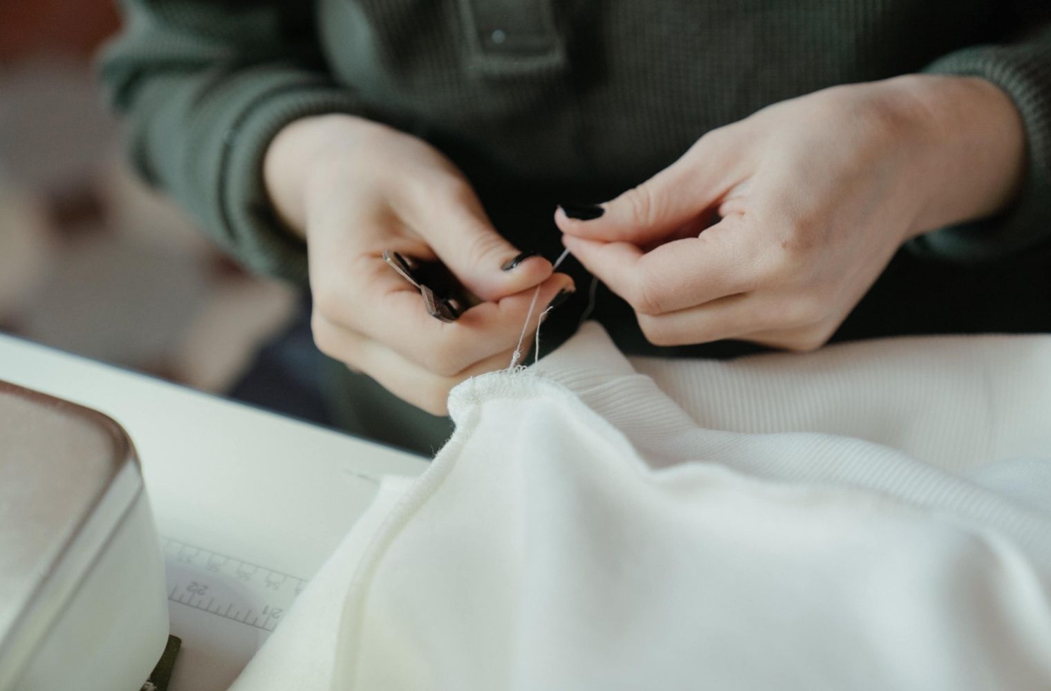 Woman fixing her clothes by sewing it