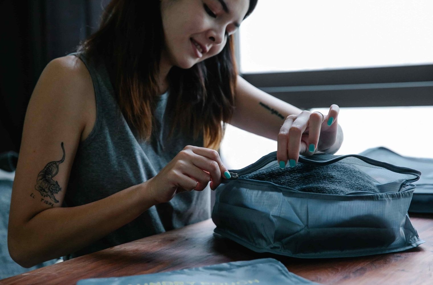 Woman putting clothes away in storage bags