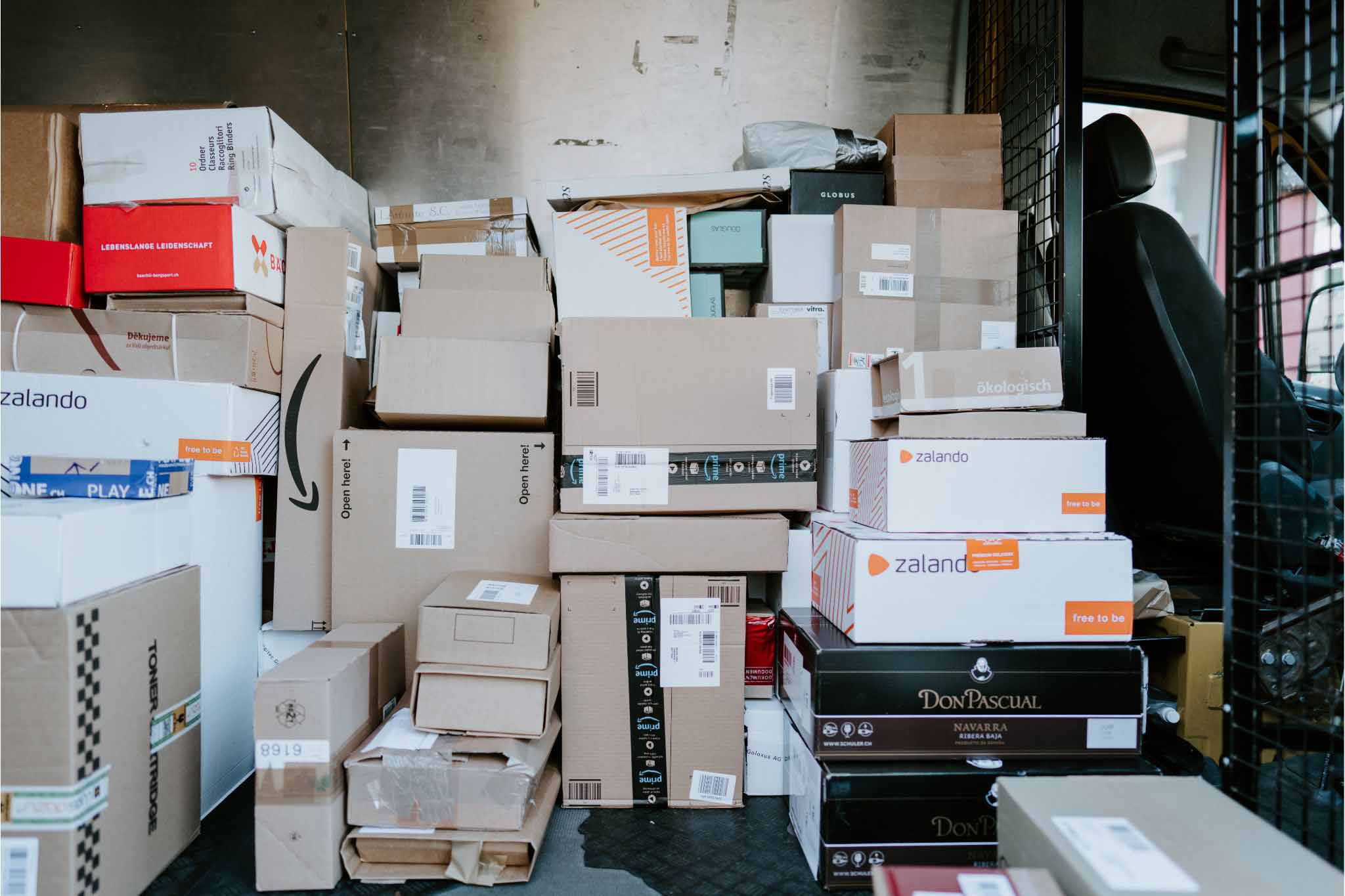 A delivery truck fulled with many packages from many online retailers