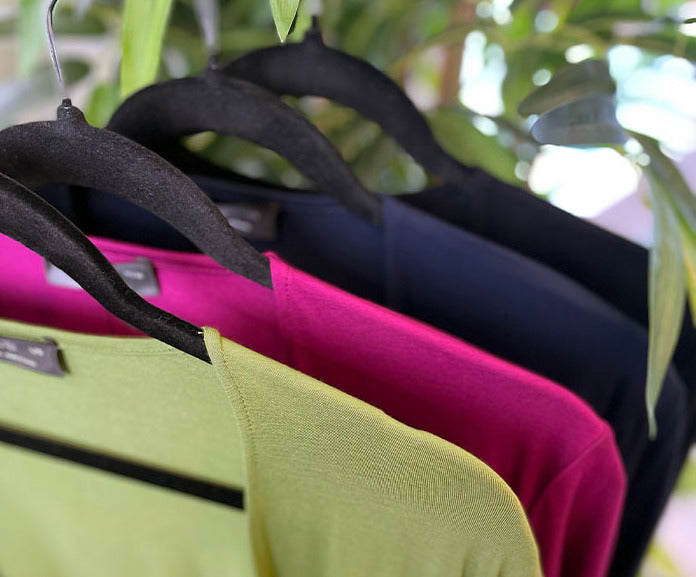 Colourful Miik clothing on hangers
