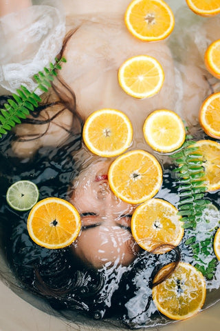 Girl With Face Under Water and Orange Slices Floating - 12 Easy Beauty Hacks That Can Really Save You A Lot Of Time