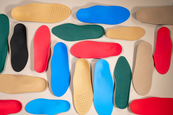 Orthopedic insoles lined on wooden surface