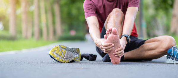 Young adult male massaging his muscle pain