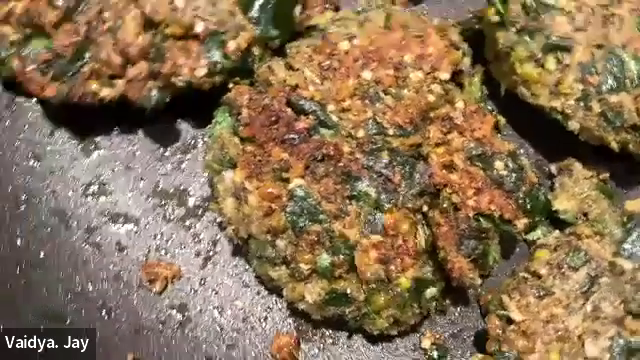 MUNG BEAN SPINACH PATTIES being fried in a pan