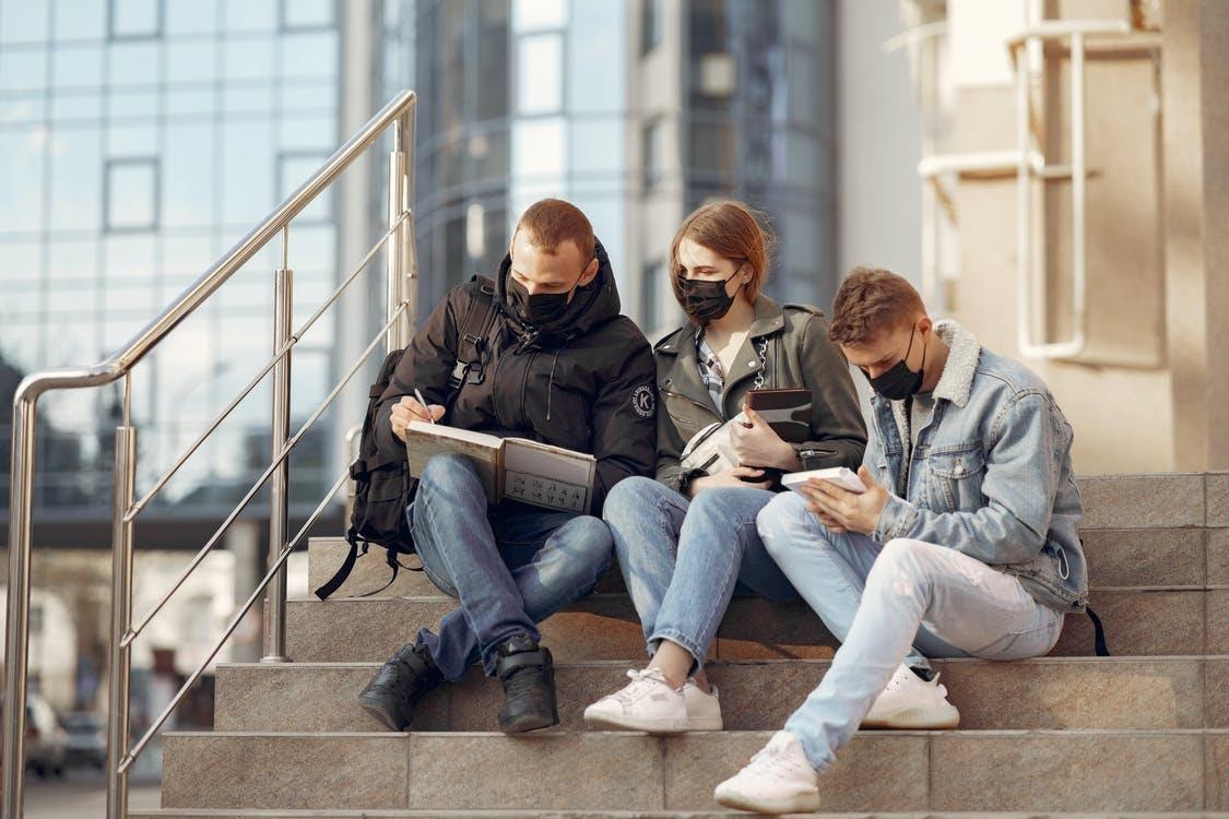 Three people wearing masks