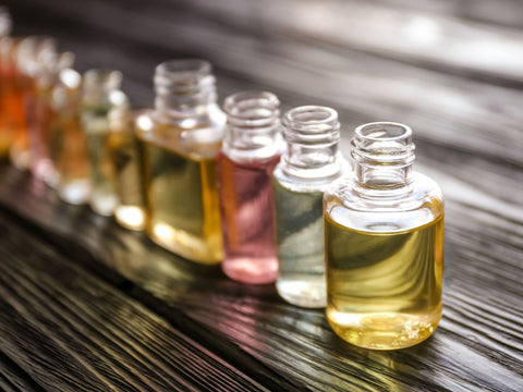 Colorful Bottles of Perfume Oils on a Wooden Table