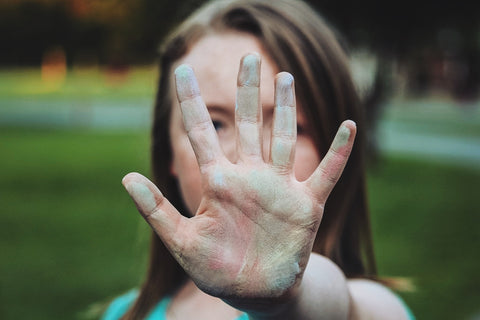 Girl with hand up showing stop