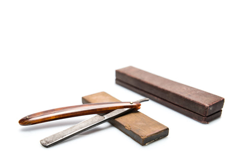 Sharpening a straight razor on a whetstone