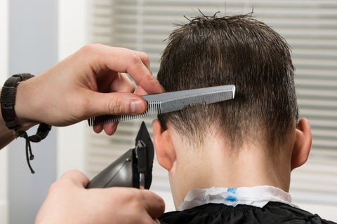Using a clipper and a comb to cut hair