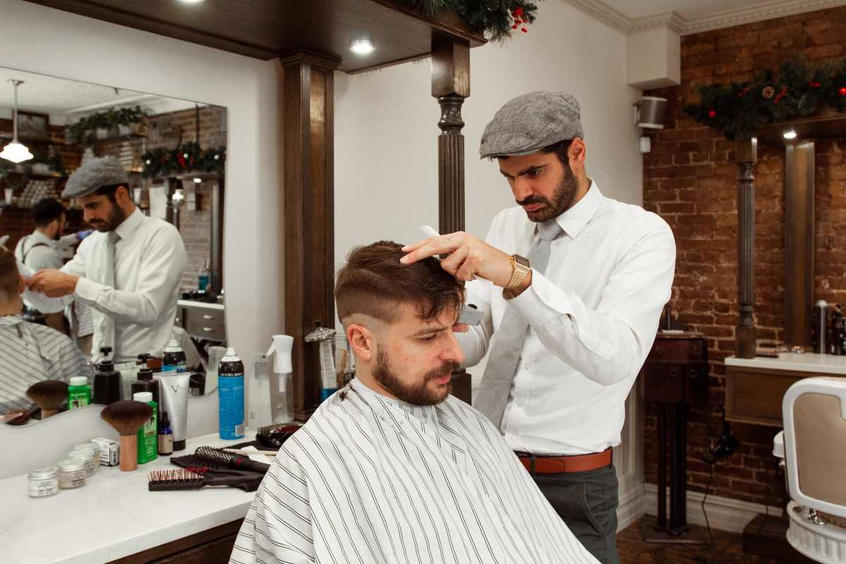 A hairdresser performing a dry haircut