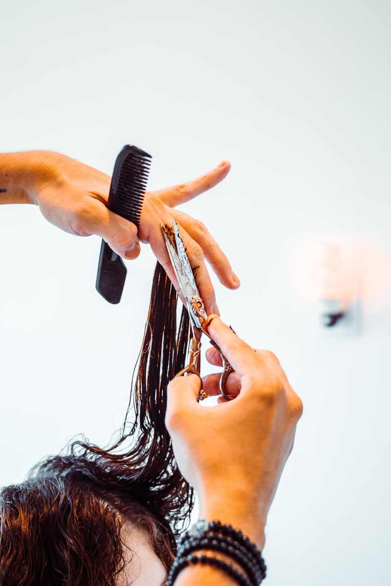 A hairdresser performing stroke cutting techniques