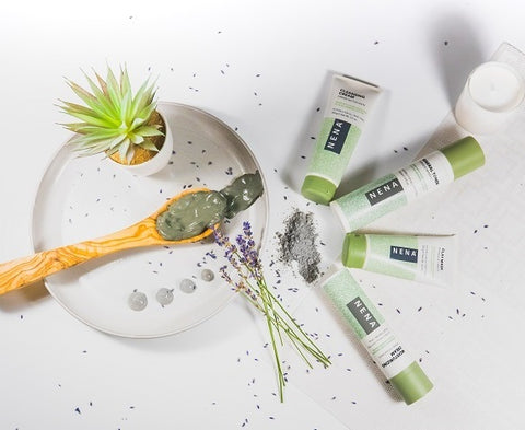 Nena glacial skincare products flat lay with clay on wooden spoon and lavender