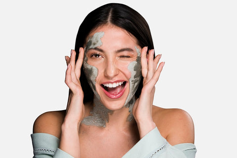 women wearing a clay mask