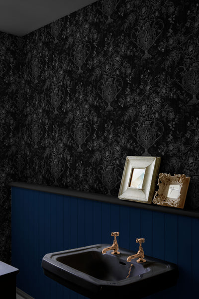 Traditional wallpaper installed in a deep navy bathroom.