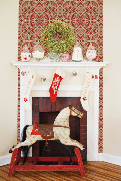Moroccan Stamp wallpaper installed behind a festive holiday mantel