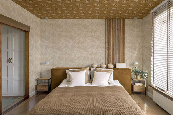Bedroom with an abstract geometric wallpaper on the ceiling and a subtle floral wallpaper on the walls.