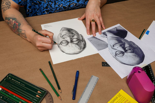 Artist drawing a portrait to be used to create the Iconographic wallpaper design